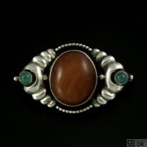 William Fuglede 1907-1937. Art Nouveau Silver Brooch with Amber and Green Agate.