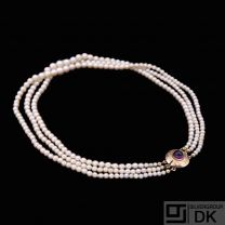 J. Bjerring Sørensen. Three-Strand Pearl Necklace with 14k Gold Lock with Amethyst.