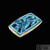 Jais Nielsen. Ceramic Brooch with blue glace and gilded silver mounting.