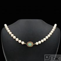 Pearl Necklace with 14k Gold and cabochon Jade lock.